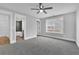 Bedroom with carpet, ceiling fan, view to bath and large window at 153 Alaina Rd, Holly Springs, GA 30115