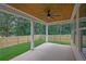 Covered patio features a wooden ceiling, ceiling fan, and view of the fenced backyard at 153 Alaina Rd, Holly Springs, GA 30115