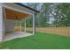 Covered patio is perfect for relaxation, featuring a ceiling fan and views of the lush backyard at 153 Alaina Rd, Holly Springs, GA 30115
