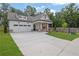 Charming two-story home featuring a manicured lawn, craftsman architecture, and a two-car garage at 153 Alaina Rd, Holly Springs, GA 30115
