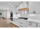 Bright, modern kitchen features white cabinetry, stainless steel appliances, and quartz countertops at 153 Alaina Rd, Holly Springs, GA 30115