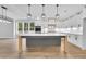 Modern kitchen with a large island, white cabinetry, stainless steel appliances, and pendant lighting at 153 Alaina Rd, Holly Springs, GA 30115