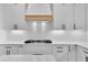 Stove top with backsplash and range hood at 153 Alaina Rd, Holly Springs, GA 30115