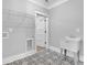 Bright laundry room boasts patterned tile floors, utility sink, and convenient shelving at 153 Alaina Rd, Holly Springs, GA 30115