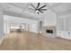 Expansive living room showcasing hardwood floors, coffered ceilings, and an open-concept layout at 153 Alaina Rd, Holly Springs, GA 30115