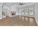 Bright, open living room featuring a cozy fireplace, coffered ceilings, and large windows at 153 Alaina Rd, Holly Springs, GA 30115