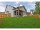 Expansive backyard features covered patio and lush green lawn, ideal for outdoor enjoyment at 153 Alaina Rd, Holly Springs, GA 30115