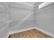 Spacious walk-in closet with wire shelving and wood flooring at 153 Alaina Rd, Holly Springs, GA 30115