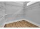 Large walk-in closet with shelving and wood flooring at 153 Alaina Rd, Holly Springs, GA 30115