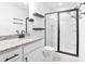 Modern bathroom features granite counters, sleek black fixtures, and a glass-enclosed shower at 1958 Dillon Dr, Lithonia, GA 30058
