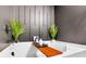 Close up of white bathtub with wooden tray and decor at 1958 Dillon Dr, Lithonia, GA 30058