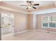 Bedroom with carpet, window, and open entry to bathroom with vanity at 1958 Dillon Dr, Lithonia, GA 30058