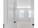 Bright bedroom view through an open doorway, showcasing the light-filled space at 1958 Dillon Dr, Lithonia, GA 30058