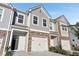 Charming townhome with a brick-accented facade, a two-car garage, and well-maintained landscaping at 1958 Dillon Dr, Lithonia, GA 30058