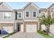 Charming townhouse exterior with stone accents, gray siding, and attached garage at 1958 Dillon Dr, Lithonia, GA 30058