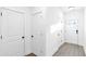Bright hallway with white doors, clean lines, and modern flooring at 1958 Dillon Dr, Lithonia, GA 30058
