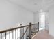 Bright hallway features wood and iron railing, leading to sunlit rooms at 1958 Dillon Dr, Lithonia, GA 30058