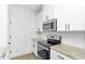 Well-lit kitchen with granite countertops, stainless steel appliances, and white cabinets at 1958 Dillon Dr, Lithonia, GA 30058