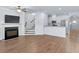 Open-concept living room with fireplace, staircase, and adjacent kitchen at 1958 Dillon Dr, Lithonia, GA 30058
