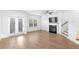 Spacious living room with fireplace, hardwood floors, and bright natural light from the patio doors at 1958 Dillon Dr, Lithonia, GA 30058