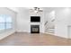 Bright living room with fireplace, ceiling fan, and hardwood floors at 1958 Dillon Dr, Lithonia, GA 30058