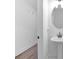 Neat powder room featuring a pedestal sink, oval mirror, and clean white walls at 1958 Dillon Dr, Lithonia, GA 30058