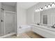 Bright bathroom with soaking tub, walk-in shower, and dual sink vanity at 196 Al Jennah Blvd, Locust Grove, GA 30248
