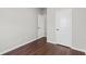 Neutral bedroom featuring wood-look floors and two white doors at 196 Al Jennah Blvd, Locust Grove, GA 30248