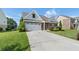 Beautiful front exterior showcasing well-maintained lawn, tasteful shrubbery, and attached two-car garage at 196 Al Jennah Blvd, Locust Grove, GA 30248