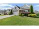 Inviting home exterior with manicured lawn, mature shrubbery, and convenient two-car attached garage at 196 Al Jennah Blvd, Locust Grove, GA 30248