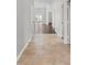 Bright hallway with neutral tile flooring leading to an open concept living area with hardwood floors at 196 Al Jennah Blvd, Locust Grove, GA 30248
