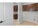 Laundry room featuring granite countertops and dark cabinets at 196 Al Jennah Blvd, Locust Grove, GA 30248