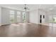 Bright living room with high ceilings, hardwood floors, large windows, and views into the breakfast area at 196 Al Jennah Blvd, Locust Grove, GA 30248