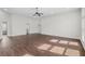 Expansive living room featuring hardwood floors, lots of natural light, and ample space for furniture at 196 Al Jennah Blvd, Locust Grove, GA 30248