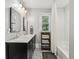 Bright bathroom featuring a double sink vanity with marble countertop, subway tile shower, and patterned floor tiles at 207 E Hightower E Trl, Social Circle, GA 30025