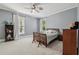Comfortable bedroom with a ceiling fan, two windows, and neutral gray paint at 207 E Hightower E Trl, Social Circle, GA 30025