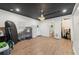Spacious bonus room with hardwood floors, chandelier lighting, and an adjacent bathroom with charming wallpaper at 207 E Hightower E Trl, Social Circle, GA 30025