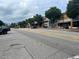 City street with shops and restaurants lining the sidewalks and trees along the street at 207 E Hightower E Trl, Social Circle, GA 30025