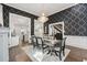 The formal dining room is decorated with black and gray wallpaper and a large chandelier at 207 E Hightower E Trl, Social Circle, GA 30025