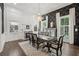 Formal dining room features detailed trim work, dark wallpaper and elegant lighting at 207 E Hightower E Trl, Social Circle, GA 30025