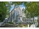Side view of a gray two-story home with a welcoming porch and landscaped yard at 207 E Hightower E Trl, Social Circle, GA 30025