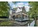 Side view of a lovely two-story house with a spacious wrap-around porch and manicured lawn at 207 E Hightower E Trl, Social Circle, GA 30025