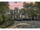 The exterior is a three-story home featuring neutral gray siding and a rear carport and entertainment space at 207 E Hightower E Trl, Social Circle, GA 30025