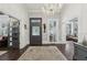 Grand foyer featuring dark wood floors, a chandelier, and an elegant entrance at 207 E Hightower E Trl, Social Circle, GA 30025