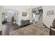 Elegant foyer showcasing a staircase, dark wood floors, and views of the living room at 207 E Hightower E Trl, Social Circle, GA 30025