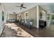 Spacious front porch with comfortable seating and a ceiling fan, perfect for relaxing outdoors at 207 E Hightower E Trl, Social Circle, GA 30025
