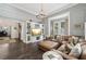Bright living room boasts a comfortable leather couch and built-in shelving unit at 207 E Hightower E Trl, Social Circle, GA 30025
