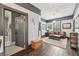 Cozy living room with hardwood floors, fireplace, leather sofa, and natural light from the window at 207 E Hightower E Trl, Social Circle, GA 30025