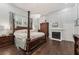 Bright main bedroom featuring wood floors, chandelier, and fireplace at 207 E Hightower E Trl, Social Circle, GA 30025