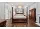 Spacious main bedroom with hardwood floors and four poster bed at 207 E Hightower E Trl, Social Circle, GA 30025